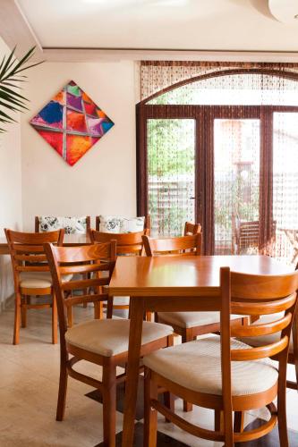 a dining room with tables and chairs and a kite on the wall at Silistar Hotel in Rezovo