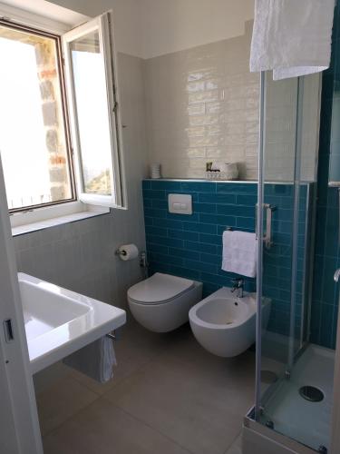 a bathroom with a toilet and a sink and a shower at La Casa dei Panorami di Colobraro in Colobraro