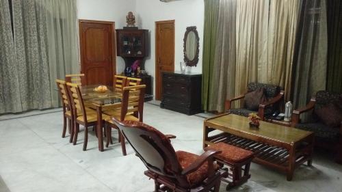 a living room with a dining room table and chairs at Aadhaar in Lucknow