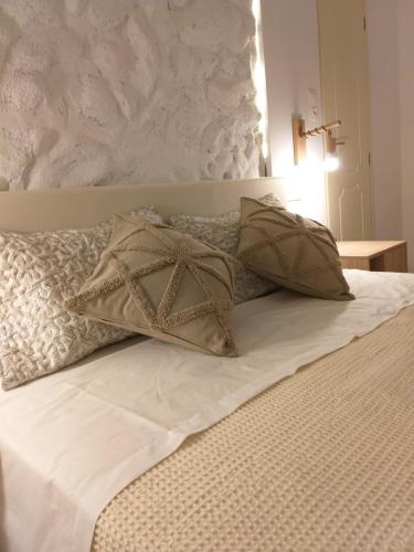 a bed with two pillows on top of it at Greek Blue Apartment! small apartment, small bathroom in Plakias