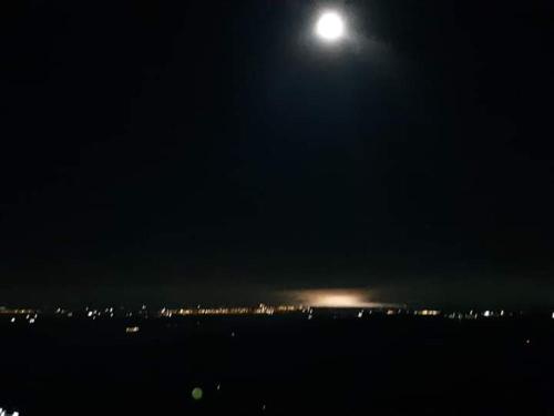 a full moon over a city at night at La Casa dei Panorami di Colobraro in Colobraro