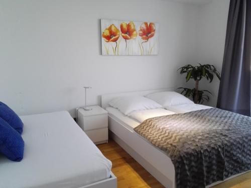a bedroom with two beds and a painting on the wall at My room serviced apartment-Messe in Munich