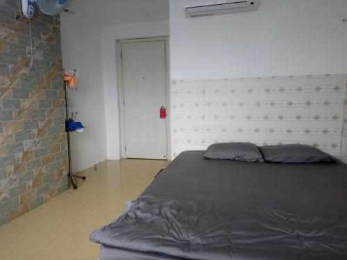 a bedroom with a bed and a brick wall at Lan Thai Ngoc Hotel in Cao Lãnh