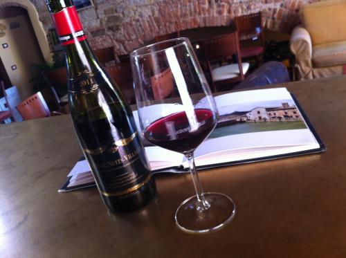 a bottle of wine and a glass on a table at La Locanda Di San Francesco in Montepulciano