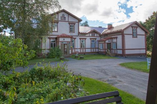 una casa grande con una entrada delante de ella en Löydön Kartano en Ristiina