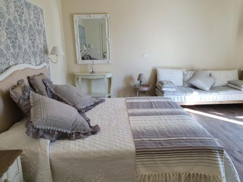 a bedroom with a bed and a couch at Romantic Home in Sirmione