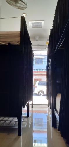 a row of beds in a room with a car at Chaweng best hotel and hostel samui in Chaweng