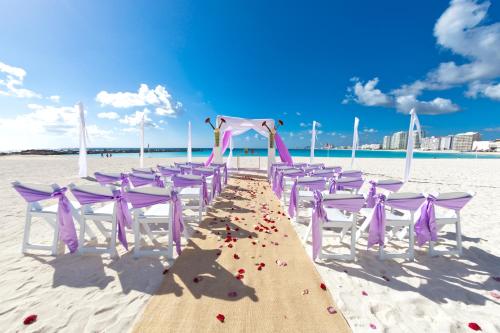 a row of tables and chairs on the beach at Krystal Grand Cancun All Inclusive in Cancún