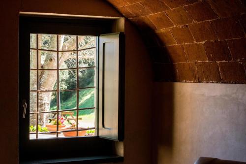 a window in a room with a view of a garden at Can Margarit in Calonge