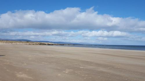 an empty beach with the ocean in the background at No42 Wild Goose in Dornoch