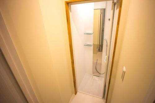 a bathroom with a shower and a toilet in it at SHARIN in Kanazawa