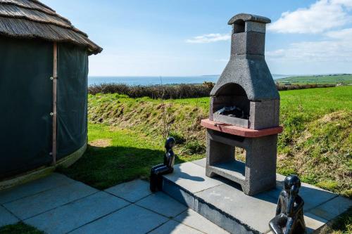 a outdoor pizza oven sitting on a patio at Ocean View,Kinsale, Hosted by Exquisite holiday homes, sleeps 22 in Kinsale