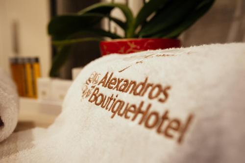 a white pillow with the wordsagents of benjamindownsholmride on it at Alexandros Boutique Hotel in Nafplio