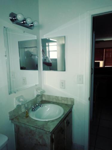 a bathroom with a sink and a mirror at Newly Furnished Large, Clean, Quiet Private Unit in Fort Lauderdale