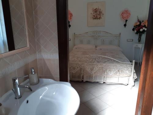 a bathroom with a sink and a bed at Il Focolare B&B in Casa Ottani