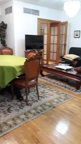 a living room with a bed and a piano at Apartment in Portela near the Airport in Lisbon