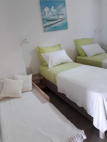 two beds sitting next to each other in a room at Villa Ligia Beach in Koundouros