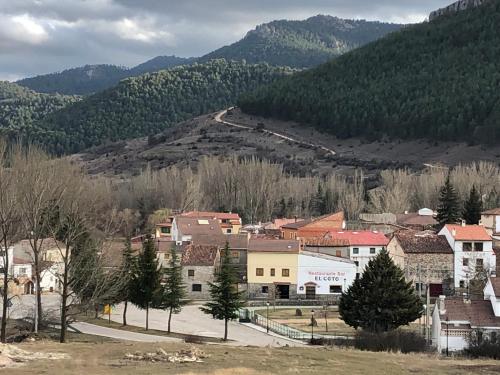 a group of buildings in a town with mountains at Casa Rural Chincha in Tragacete