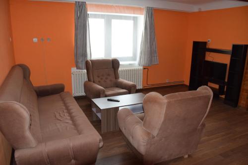 a living room with two chairs and a couch and a table at Apartmány Kvasejovice in Sušetice