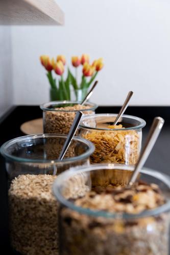 a group of containers of food with flowers in the background at Stadthotel Freilassing in Freilassing