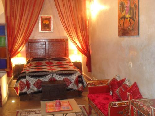 a bedroom with a bed and a couch at Riad Marlinea in Sale