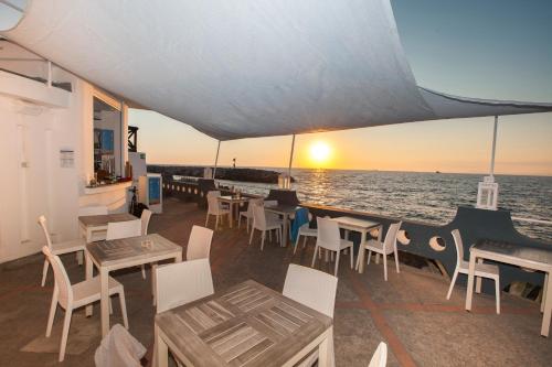 a restaurant on a boat with tables and chairs at Hotel Piccolo Paradiso in Massa Lubrense