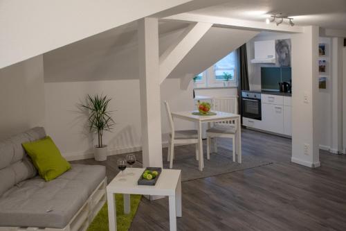 a living room with a couch and a table at Apartmenthaus Luise in Bad Schandau
