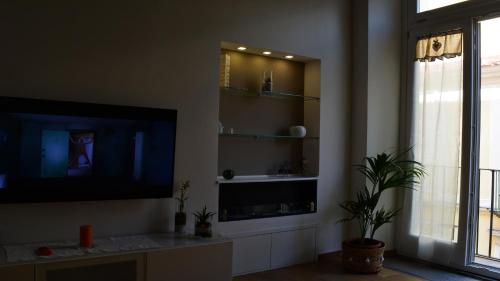 salon z telewizorem z płaskim ekranem na ścianie w obiekcie Le 13 Fontane w mieście Salerno