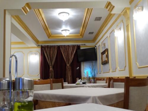 a dining room with tables and chairs and a ceiling at Vesta Hotel in Montana