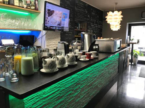 a bar in a restaurant with a counter with drinks at Apartmány Caffe & Grill in Roudnice nad Labem