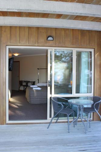 a room with a table and chairs and a bedroom at Aoraki Mount Cook Alpine Lodge in Mount Cook Village