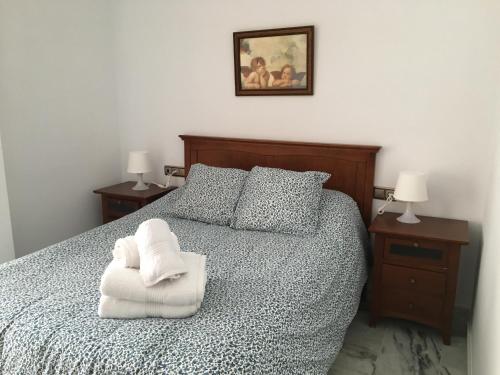 um quarto com uma cama com uma toalha branca em Apartamento céntrico em Ceuta