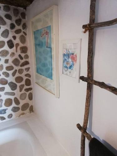a bathroom with two pictures on the wall at Casa MariSol in Arcos de la Frontera