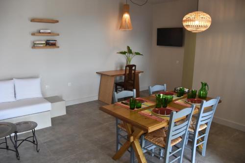 a dining room with a wooden table and chairs at Athina's Stone House in Kardamyli in Kardamili