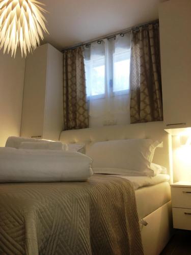 a bedroom with two beds and a window at Holiday Hvar in Vrbanj