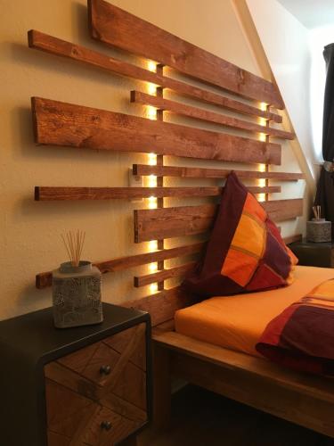 a bedroom with a bed with a wooden wall at Stadthaus Edel - Apartment Binz in Remscheid