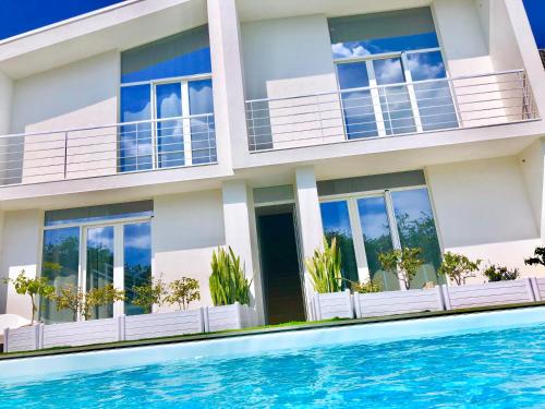 a house with a swimming pool in front of it at Casa A'Ispenza in Santa Venerina