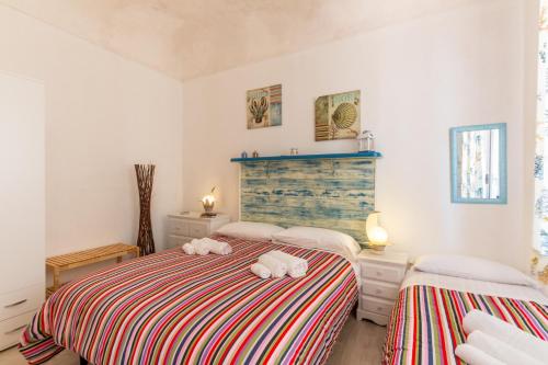 a bedroom with two beds with stuffed animals on them at Casa Vacanza Teti in Marina di Ragusa