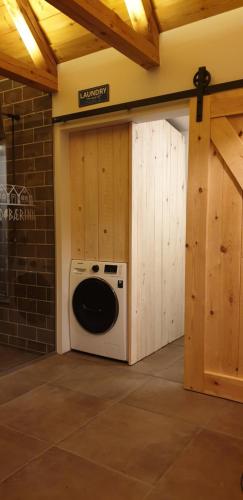 a washer and dryer in a garage with a door at Íslandsbærinn /Old Farm in Akureyri