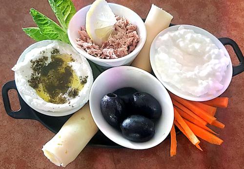 a tray with different types of food on a table at Besof Haderech in Misgav ‘Am