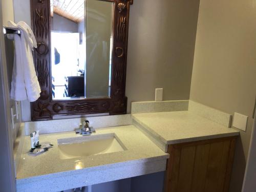 a bathroom with a sink and a mirror at Red Canyon Cabins in Kanab