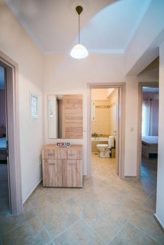 a bathroom with a sink and a toilet in a room at Xristiana's House by CorfuEscapes in Kastanéa