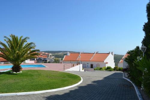 a driveway leading to a villa with a swimming pool at Coral Villa in Ericeira