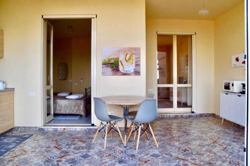 a dining room with a table and two chairs at Casa Limone in Quartu sant Elena, Capitana, with sea view! in Capitana