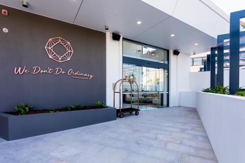 a lobby of a building with a sign on the wall at Ruby Gold Coast by CLLIX in Gold Coast