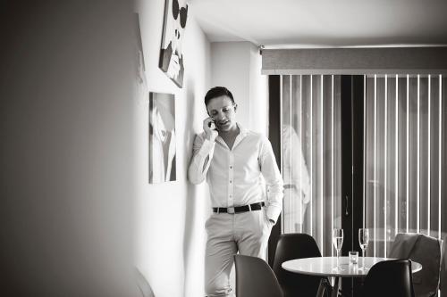 a man talking on a cell phone in a room at Suite del Amore in Babilafuente