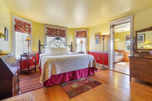 a bedroom with a bed and a dresser and a television at After Eight Bed and Breakfast in Ronks