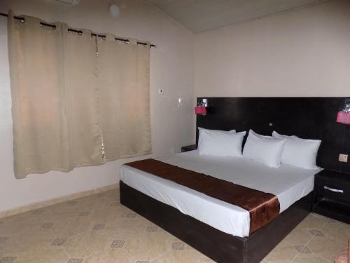 a bedroom with a large bed in a room at Posh Apartments Business Hotel in Ikeja