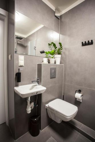 a bathroom with a toilet and a sink at Chmielna - Stay Well Warsaw in Warsaw