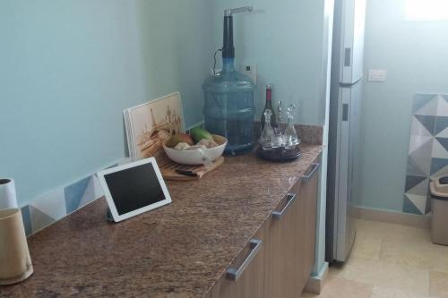 
a kitchen counter with a laptop computer on it at Cap Cana Cap Blue in Punta Cana
